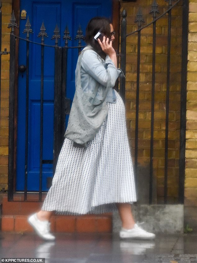 Bumping along nicely: The 34-year-old actress sported a full-length monochrome dress, which boasted a flowing polka dot skirt and black fitted top