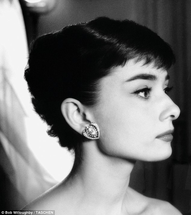 Classic beauty: The star wears striking earrings during a photo session at Paramount Studios in 1953