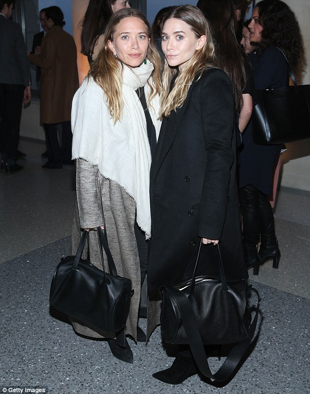 Layered: The pair bundled up in effortlessly chic looks while wearing matching black suede boots
