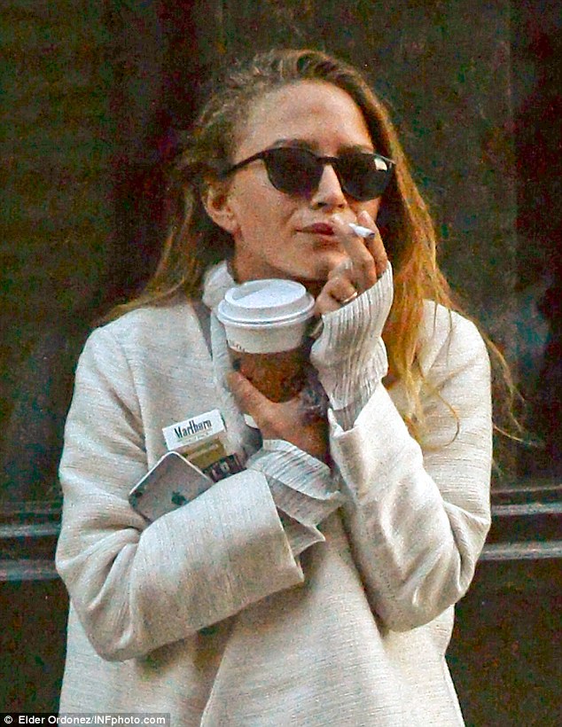 Sister smoke break: In her first sighting since the wedding, Mary-Kate Olsen (L) was spotted smoking a Marlboro Light alongside fraternal twin sister Ashley in Manhattan on Tuesday