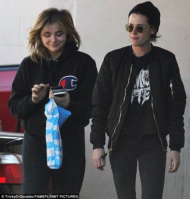 Having a laugh: Kristen wore her brunette tresses wavy beneath her knitted hat and opted for a makeup free face; seen with Chloe (l)