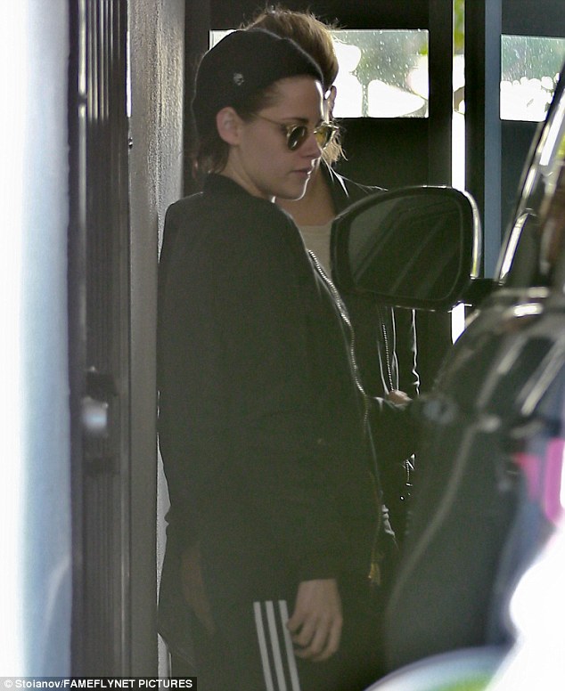 Workout wear: The 26-year-old Twilight star donned a stylish bomber jacket with black gym pants 
