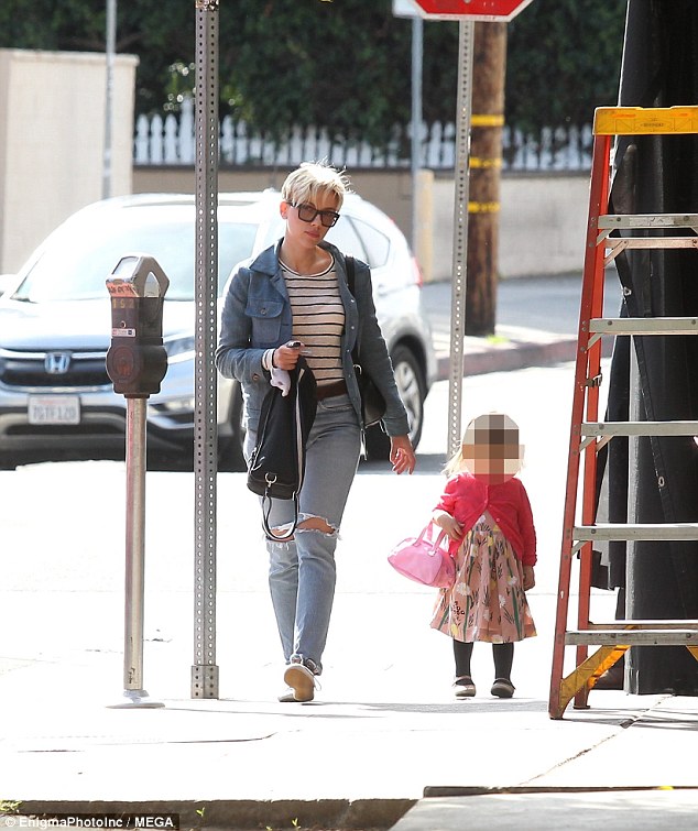 Sweet: The 32-year-old dressed casually for the outing, wearing a striped top and ripped jeans as her two-year-old tot walked alongside her