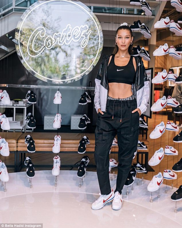 Slender: The top model paraded around the shopping centre in nothing but a black sports bra and luxe tracksuit bottoms, to show off her slim figure and toned stomach for all to see
