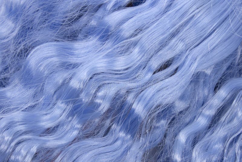 Metallic Blue wavy synthetic hair background. This is a photograph of Metallic Blue wavy synthetic hair background royalty free stock image